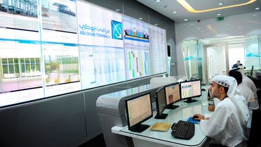 Employees work in the control room at Khalifa Port during its opening in Taweelah, Abu Dhabi September 1, 2012. Abu Dhabi launched operations at a multi-billion dollar port facility on Saturday, seeking to diversify its oil-based economy with a project that could intensify competition for the region's shipping traffic with neighbouring emirate Dubai. Abu Dhabi Ports Co (ADPC) said Khalifa Port, built on a man-made island in the Taweelah area, and its adjacent Khalifa Industrial Zone would together be two-thirds the size of Singapore when fully built. REUTERS/Ben Job (UNITED ARAB EMIRATES - Tags: MARITIME BUSINESS)