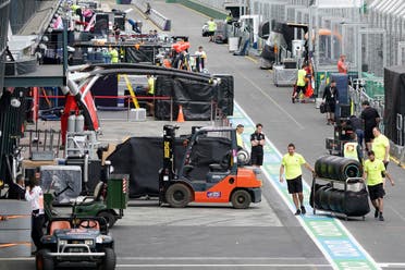 Workers pack up in pit lane after the cancellation of the Australian Formula One Grand Prix in Melbourne, Friday, March 13, 2020.