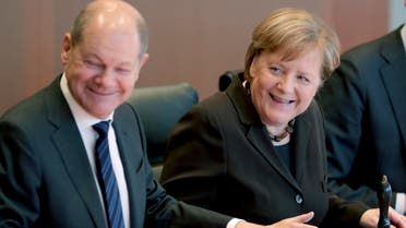 German Chancellor Angela Merkel, right, smiles as she and German Finance Minister Olaf Scholz, left, arrive for the weekly cabinet meeting at the Chancellery in Berlin, Germany, on Wednesday, February 19, 2020. (AP)