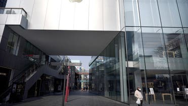 A man wearing a face mask walks past a closed Apple store at Sanlitun, as the country is hit by an outbreak of the new coronavirus, in Beijing, China February 7, 2020. (Reuters)