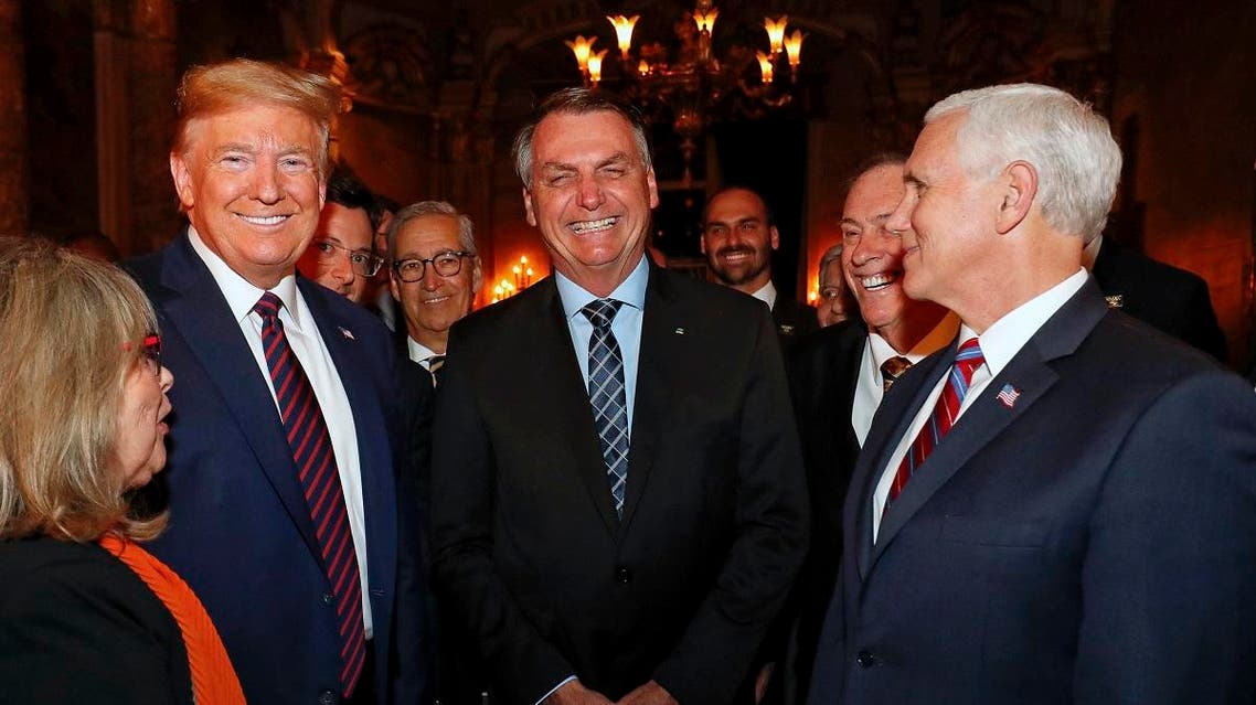 In this March 7, 2020 photo, Brazil’s President Bolsonaro, center, stands with President Trump and Vice President Pence, right, and Wajngarten, behind Trump partially covered, during a dinner in Florida. (AP)