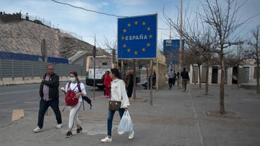 People walk near the Spanish border with Morocco in Ceuta. Morocco suspended air and sea links with France and Spain, and closed its border with two Spanish North African enclaves, officials said. (AFP)