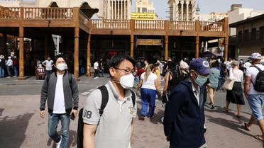 Tourists wear protective face masks, following the outbreak of the new coronavirus, as they walk at the Grand Souq in old Dubai, United Arab Emirates March 2, 2020. (Reuters)