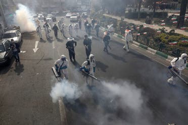 Firefighters disinfect a square against the new coronavirus, in western Tehran, Iran, Friday, March 13, 2020. (AP)