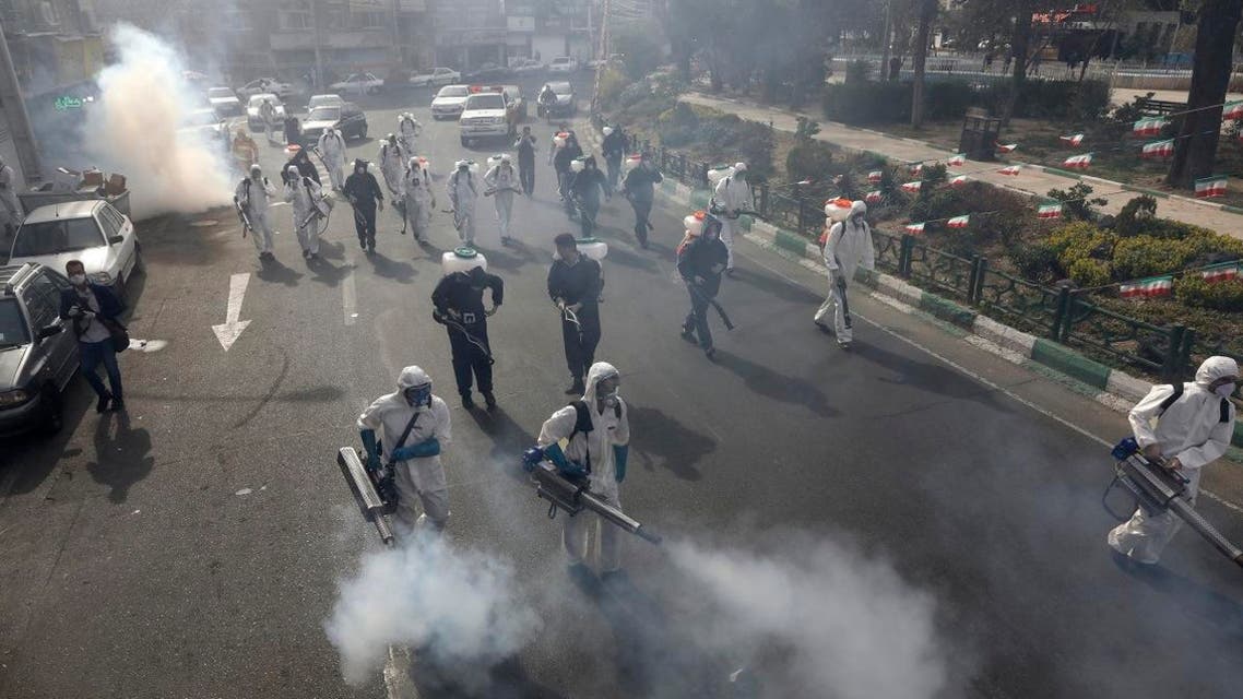 Firefighters disinfect a square against the new coronavirus, in western Tehran, Iran, Friday, March 13, 2020. (AP)