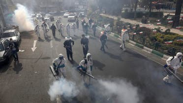 Firefighters disinfect a square against the new coronavirus, in western Tehran, Iran, Friday, March 13, 2020. (AP)