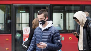 A man wears a protective mask as he walks on Oxford Street in London. (Reuters)