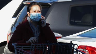 MELVILLE, NEW YORK - MARCH 14: As the coronavirus continues to spread across the United States, a customer wearing a face mask walks into Costco on March 14, 2020 in Melville, New York. The World Health Organization declared coronavirus (COVID-19) a global pandemic on March 11th. Bruce Bennett/Getty Images/AFP