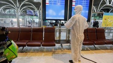 A member of Iraqi medical team wearing a protective suit sprays grounds and lounges of Baghdad International Airport with disinfectants to combat an outbreak of coronavirus, in Baghdad, Iraq March 11, 2020. (Reuters)