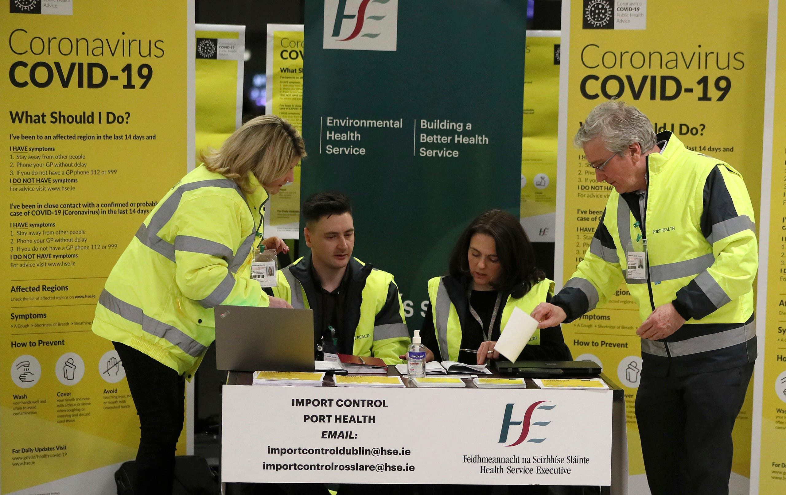 Staff conduct a public awareness campaign for COVID-19 in the baggage hall of Terminal 2 at Dublin Airport in Dublin on Feb. 28, 2020. (AP)