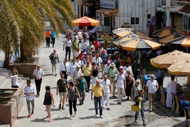 People walk on a street in the Omani capital, Muscat. (File photo: AFP)