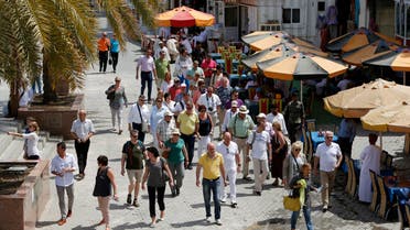 People walk on a street in the Omani capital, Muscat. (File photo: AFP)