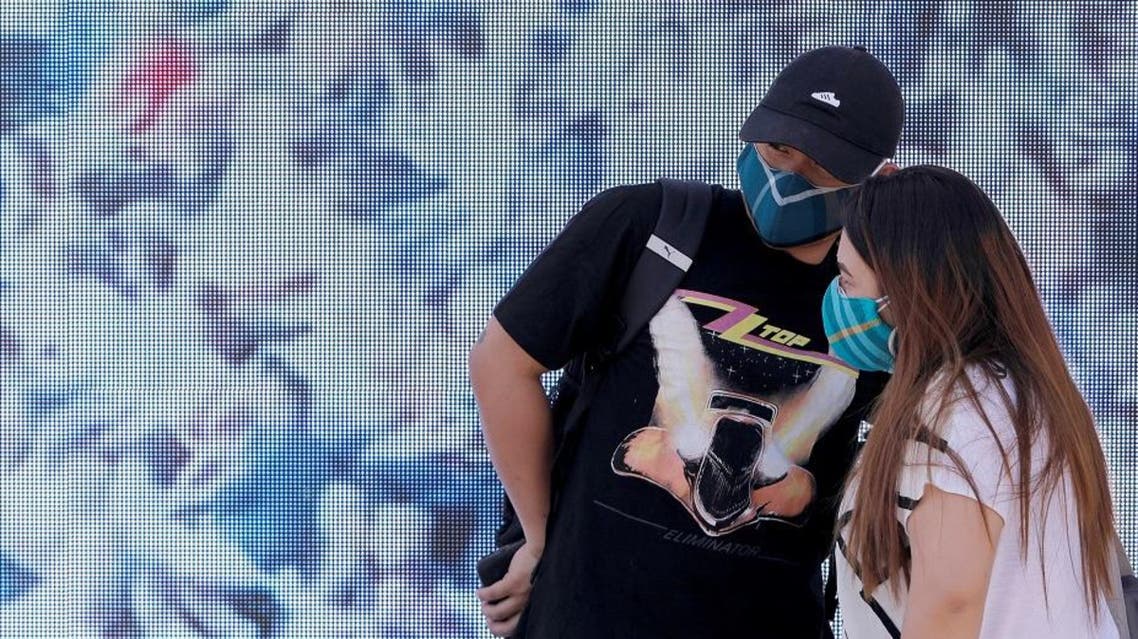 People wearing face masks stand in Federation Square after cases of the coronavirus were confirmed in Melbourne, Victoria, Australia, January 29, 2020. (Reuters)