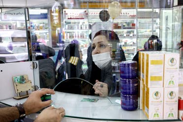A customer talks with a pharmacist at a drugstore in Tehran on Feb. 25, 2020. (AP)