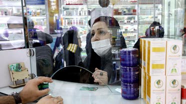 A customer talks with a pharmacist at a drugstore in Tehran on Feb. 25, 2020. (AP)