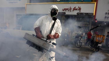 A firefighter disinfects a square against the coronavirus in Tehran on March 13, 2020. (AP)