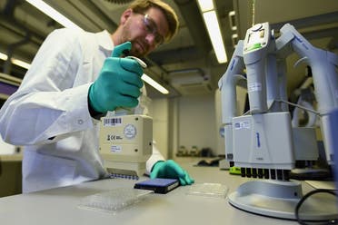 Employee Philipp Hoffmann of German biopharmaceutical company CureVac, demonstrates research workflow on a vaccine for the coronavirus at a laboratory in Tuebingen, Germany on March 12, 2020. (Reuters)