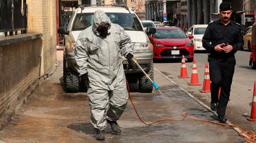A civil defense worker sprays disinfectant as a precaution against the coronavirus in Baghdad on March 11, 2020. (AP)