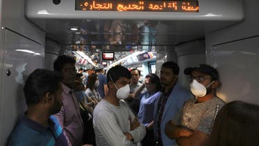 Commuters wear protective masks, following the outbreak of the coronavirus, on the metro in Dubai, United Arab Emirates, March 12, 2020. (Reuters)