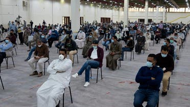 Expatriates wait for mandatory coronavirus testing in a makeshift testing centre in Mishref, Kuwait March 14, 2020. (Reuters)