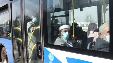 Turkish citizens wearing protective face masks sit in a bus as they are repatriated from the Umrah pilgrimage in Saudi Arabia, prior to being placed in quarantine as part of measures to limit the spread of the coronavirus, on March 15, 2020, in Ankara. (AFP)