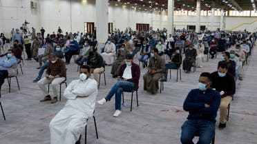 Expatriates wait for mandatory coronavirus testing in a makeshift testing centre in Mishref, Kuwait, March 14, 2020. (Reuters)
