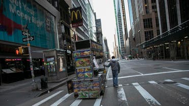 A food truck vendor pushes his cart down an empty street near Times Square in New York, on Sunday, March 15, 2020. (AP)