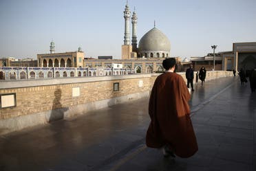 An Iranian cleric walks in front of the Shrine of Fatima Masumeh in Qom, Iran, February 09, 2020. (Reuters)