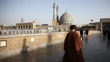 An Iranian cleric walks in front of the Shrine of Fatima Masumeh in Qom, Iran, February 09, 2020. (Reuters)