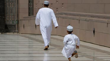 An Omani boy runs after his father as they rush to Friday Prayers at Sultan Qaboos Grand Mosque in Muscat, Oman, Friday, September 17, 2010. (File photo: AP)