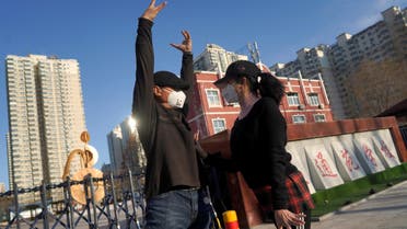 Residents wearing face masks dance, Beijing, China, March 1, 2020. (File photo: Reuters)