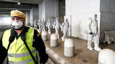 Members of the Military Emergency Unit (UME) walk to disinfect the Malaga-Costa del Sol international airport during a partial lockdown as part of a 15-day state of emergency to combat the coronavirus disease outbreak in Malaga, Spain March 16, 2020. REUTERS/Jon Nazca