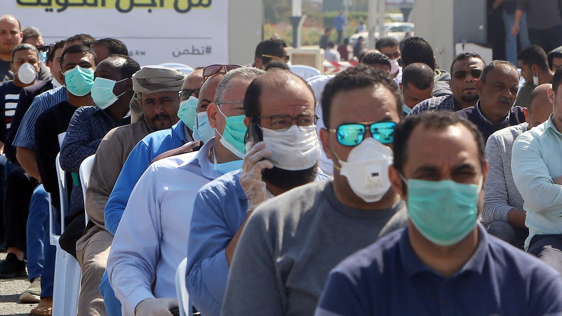 Expatriate returning from Egypt, Syria, and Lebanon arrive to be re-tested at a Kuwaiti health ministry containment and screening zone for the coronavirus in Kuwait City on March 16, 2020. (AP)