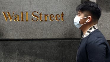 A man wears a protective mask as he walks on Wall Street during the coronavirus outbreak in New York City, New York, U.S., March 13, 2020. REUTERS/Lucas Jackson