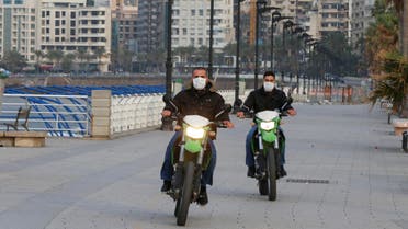 Police members wear face masks as they ride on motorbikes at Beirut's seaside Corniche as Lebanon declared a medical state of emergency on Sunday as part of the preventive measures against the spread of the coronavirus, in Beirut, Lebanon March 15, 2020. (Reuters)
