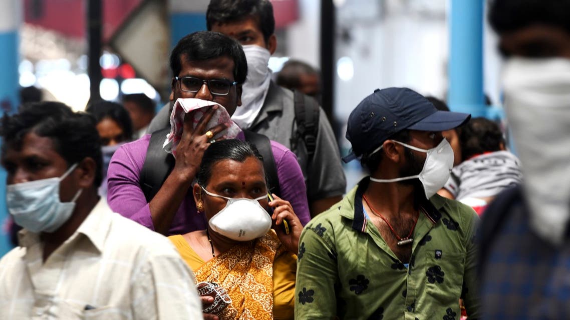 Passengers wear facemasks amid concerns over the spread of the COVID-19 novel coronavirus at M.G.R.Central railway station in Chennai on March 16, 2020.