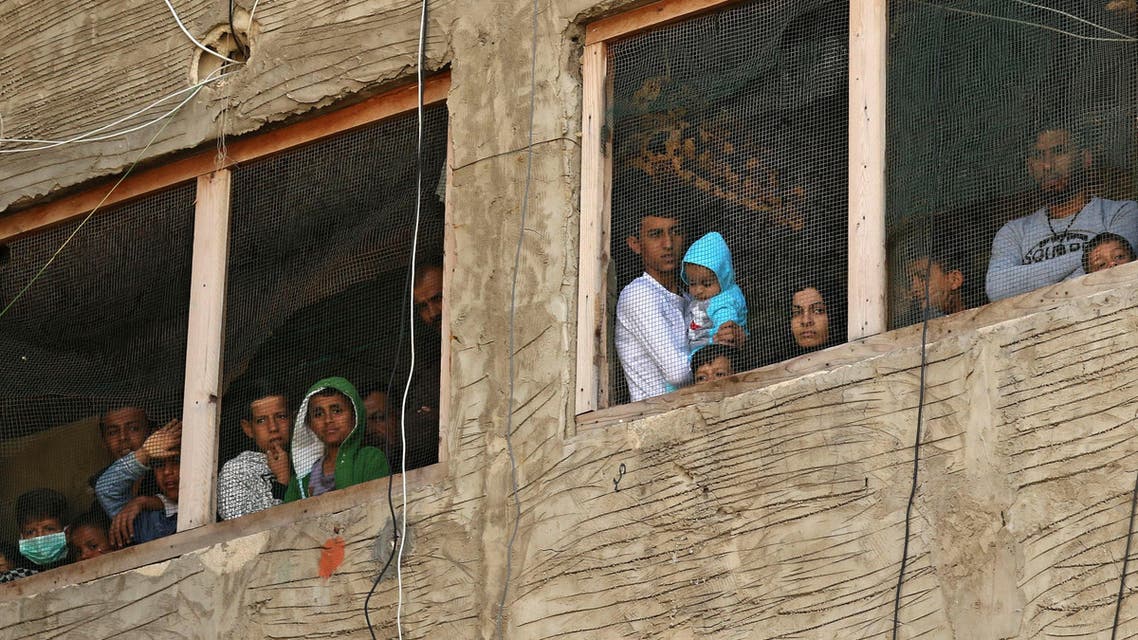 Syrian refugees in a building under construction they have been using as a shelter in the city of Sidon in southern Lebanon, on March 17, 2020. (AP)
