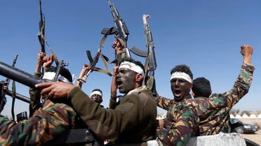 Newly recruited Houthi fighters chant slogans as they ride a military vehicle. (File photo: AFP)
