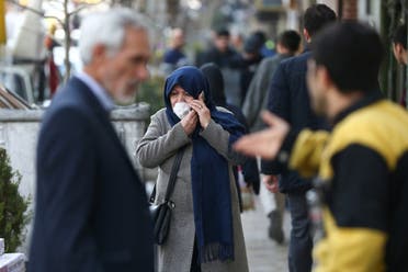 An Iranian woman wears a protective face mask, following the coronavirus outbreak, as she talks on the phone, in Tehran, Iran March 5, 2020. (Reuters)