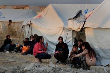 Syrians wait to receive tents and aid supplies at the Bardarash refugee camp, north of Mosul, Iraq on Oct. 17, 2019. (AP)