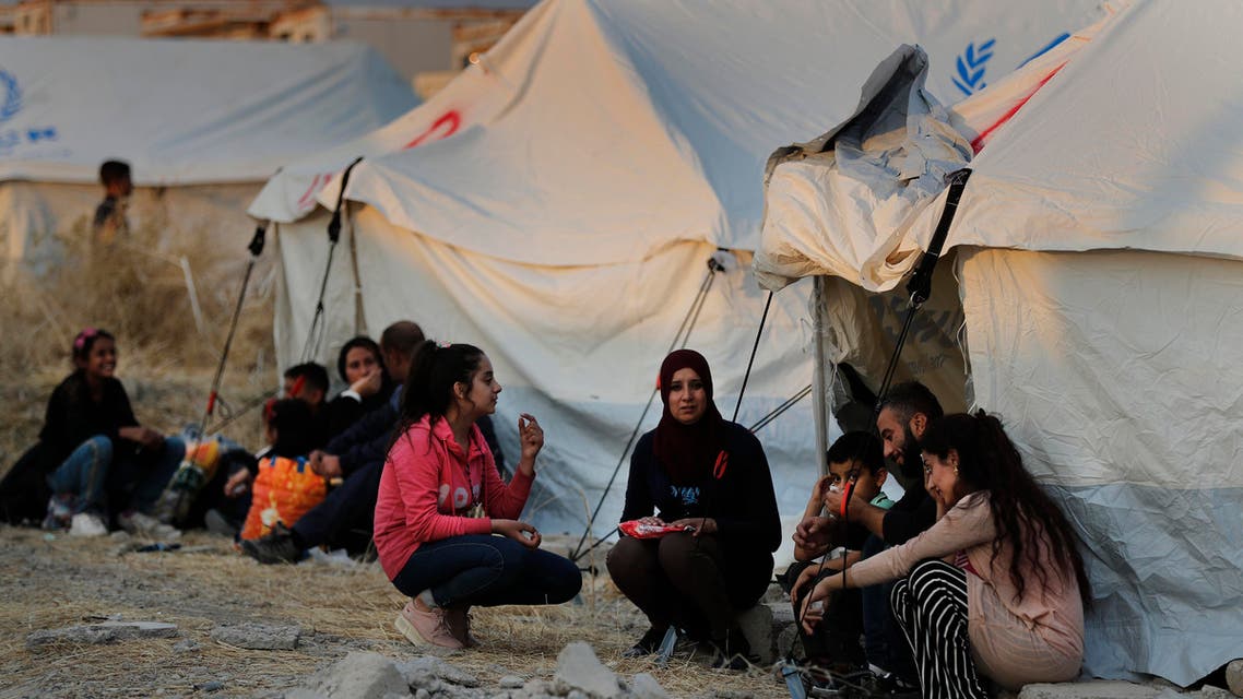 Syrians wait to receive tents and aid supplies at the Bardarash refugee camp, north of Mosul, Iraq on Oct. 17, 2019. (AP)