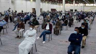 Expatriates wait for mandatory coronavirus testing in a makeshift testing centre in Mishref, Kuwait March 14, 2020.REUTERS/Stephanie McGehee
