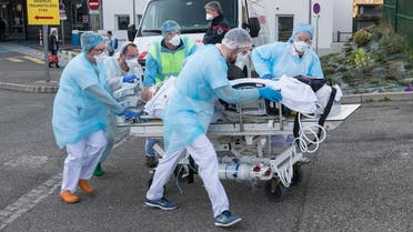 Medical staff push a patient on a gurney to a waiting medical helicopter at a hospital in eastern France, on March 17, 2020, amid the outbreak of the new Coronavirus. (AFP)