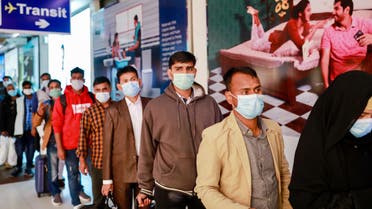 Passengers wear masks at the Hazrat Shahjalal International Airport as a preventive measure against coronavirus in Dhaka, Bangladesh. (Reuters)