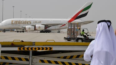 Dubai airport man watches Emirates plane - AFP