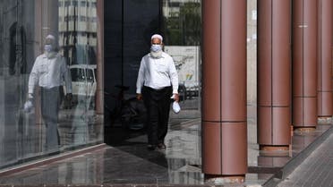 A man wearing a protective mask walks down the street in Dubai on March 18, 2020 amidst the coronavirus COVID-19 pandemic. (AFP)