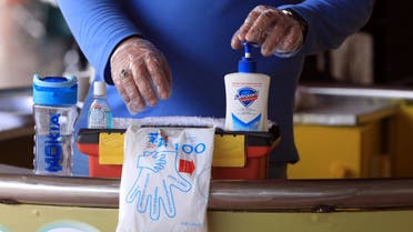 A man stands with a cleaning kit as he offers hand wash to passengers following an outbreak of the coronavirus disease (COVID-19), at a railway station in Peshawar, Pakistan March 17, 2020. (Reuters)