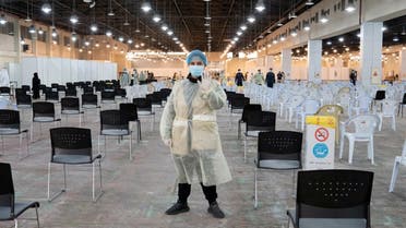 A volunteer, that directs visitors at a coronavirus testing centre, gestures at the Kuwait International Fairgrounds in Mishref, Kuwait March 18, 2020. (Reuters)