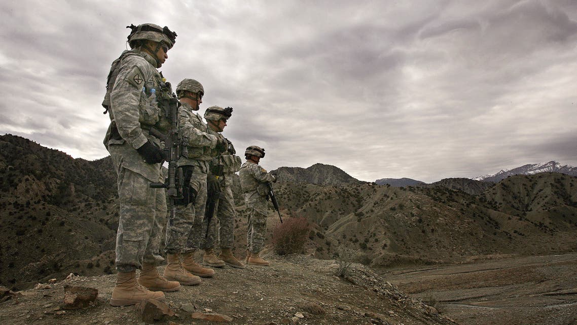 (FILES) In this file photo taken on November 20, 2006, US soldiers from 3rd Brigade Special Troops Battalion, 10th Mountain Division, look out over the landscape around Firebase Wilderness in Gardez province. American forces have started pulling out of two bases in Afghanistan, a US official said on March 10, 2020 the day peace talks between Kabul and the Taliban were due to start despite widespread violence and a political crisis. The United States is keen to end its longest-ever conflict, and under the terms of a deal signed in Doha last month has said all foreign forces will quit Afghanistan within 14 months -- provided the Taliban stick to their security commitments.