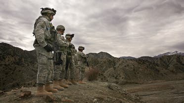 (FILES) In this file photo taken on November 20, 2006, US soldiers from 3rd Brigade Special Troops Battalion, 10th Mountain Division, look out over the landscape around Firebase Wilderness in Gardez province. American forces have started pulling out of two bases in Afghanistan, a US official said on March 10, 2020 the day peace talks between Kabul and the Taliban were due to start despite widespread violence and a political crisis. The United States is keen to end its longest-ever conflict, and under the terms of a deal signed in Doha last month has said all foreign forces will quit Afghanistan within 14 months -- provided the Taliban stick to their security commitments.